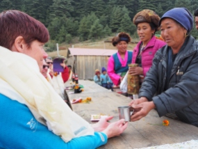 Sherpa people offering thanks with a song and special drink of raksi. The look on my face is because I was trying not to cry.